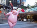 Cute pink pig sculpture with funny posture to celebrate year of the pig at World square building.